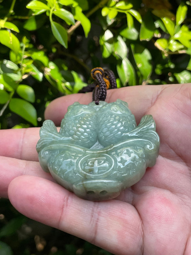 Vitreous luster and fine texture of the authentic Myanmar jade pendant JP037 showcasing a carved twin fish Feng Shui design for abundance and prosperity