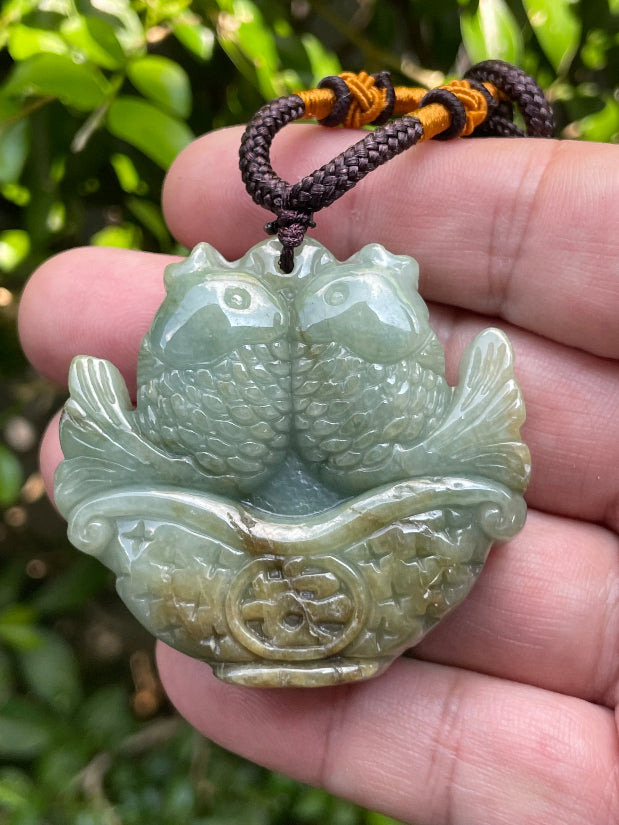 Vitreous luster and fine texture of the authentic Myanmar jade pendant JP037 showcasing a carved twin fish Feng Shui design for abundance and prosperity