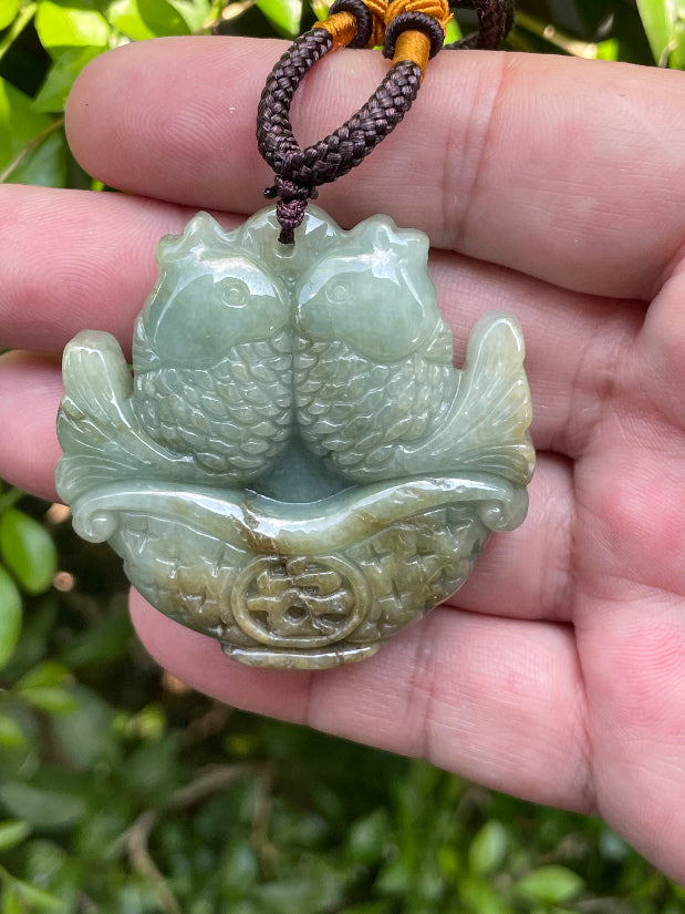Vitreous luster and fine texture of the authentic Myanmar jade pendant JP037 showcasing a carved twin fish Feng Shui design for abundance and prosperity