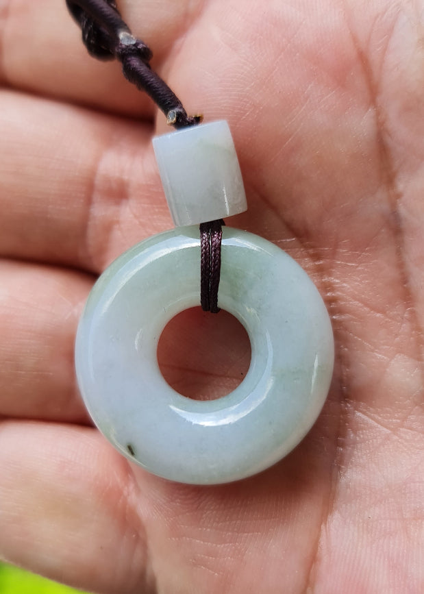 Vitreous luster and fine texture of the authentic Myanmar jade pendant JP025 showcasing a classic donut disc Feng Shui design for prosperity