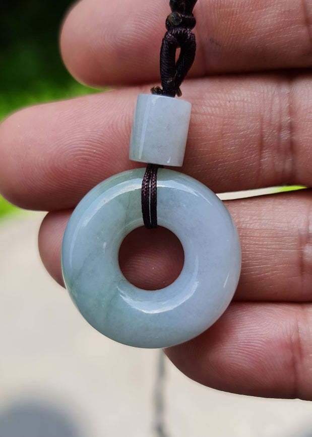 Vitreous luster and fine texture of the authentic Myanmar jade pendant JP025 showcasing a classic donut disc Feng Shui design for prosperity