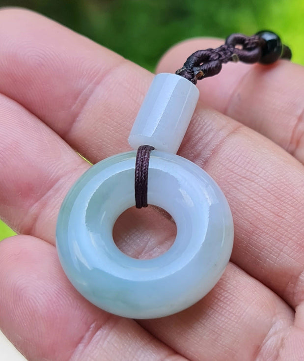 Vitreous luster and fine texture of the authentic Myanmar jade pendant JP024 showcasing a classic donut swirl Feng Shui design for unity and peace