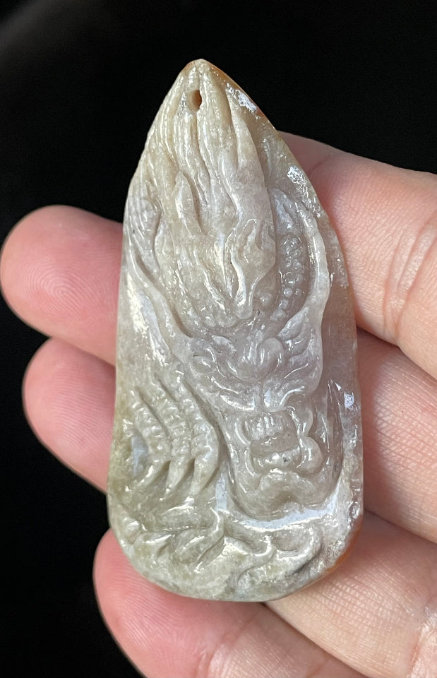 Fine texture of the authentic Myanmar jade pendant JP070 showcasing a carved dragon and fish Feng Shui design for protection and abundance