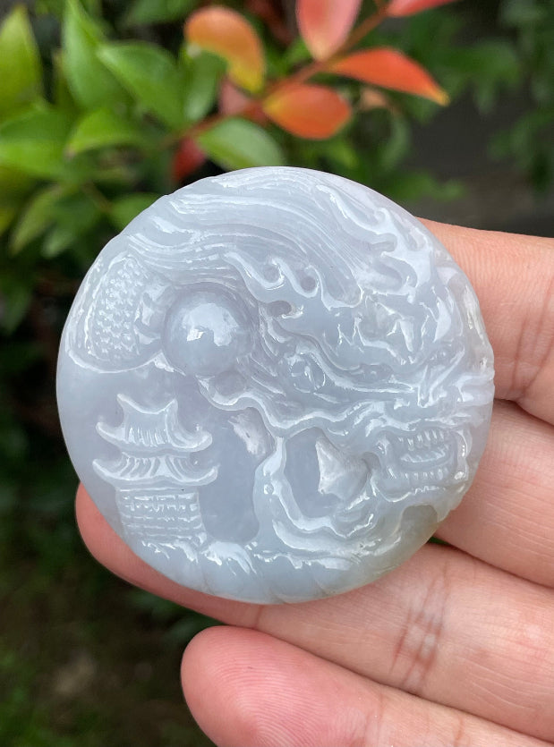 Untreated Type A Burmese jade pendant showing a smooth polished finish with an intricate Dragon and Fish Tail carving