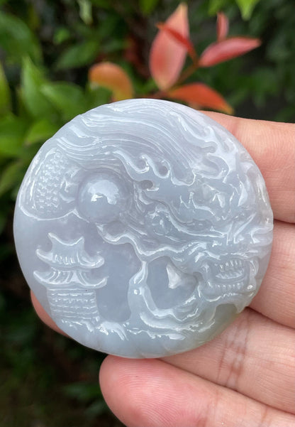 Untreated Type A Burmese jade pendant showing a smooth polished finish with an intricate Dragon and Fish Tail carving