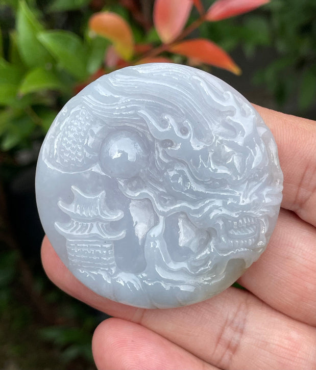 Untreated Type A Burmese jade pendant showing a smooth polished finish with an intricate Dragon and Fish Tail carving