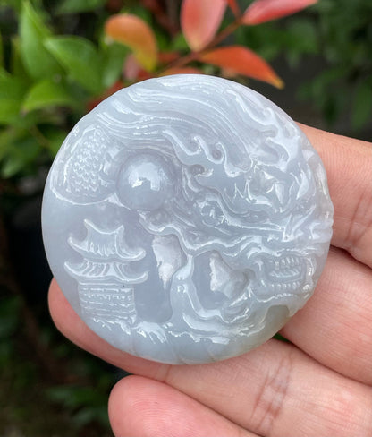 Untreated Type A Burmese jade pendant showing a smooth polished finish with an intricate Dragon and Fish Tail carving