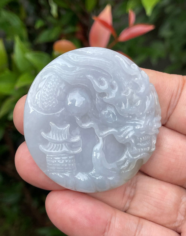 Untreated Type A Burmese jade pendant showing a smooth polished finish with an intricate Dragon and Fish Tail carving