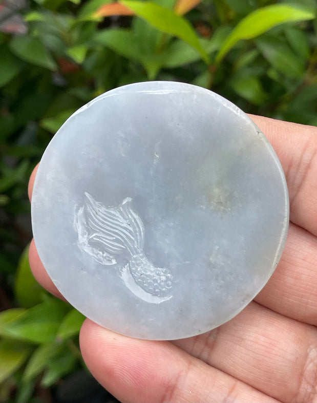 Untreated Type A Burmese jade pendant showing a smooth polished finish with an intricate Dragon carving and flame-like tail