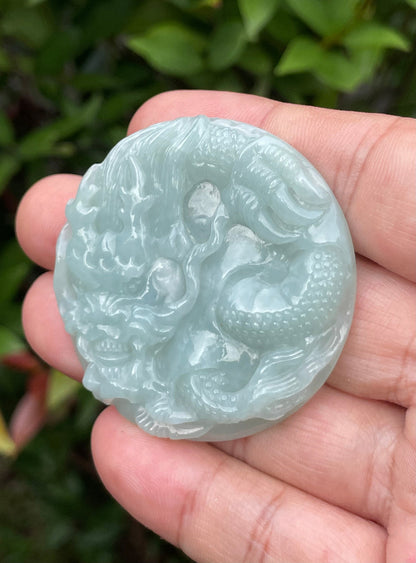 Untreated Type A Burmese jade pendant showing a smooth polished finish with an intricate Dragon carving