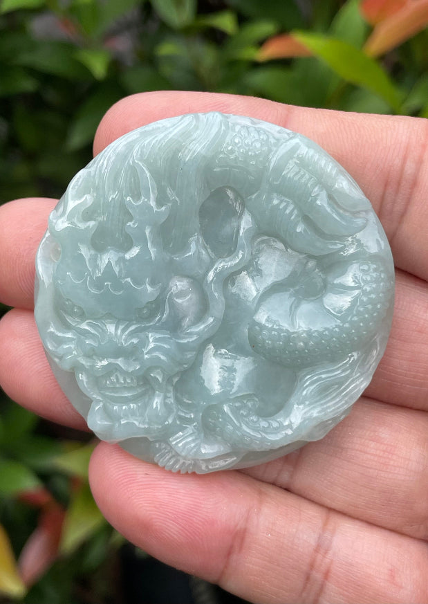 Untreated Type A Burmese jade pendant showing a smooth polished finish with an intricate Dragon carving