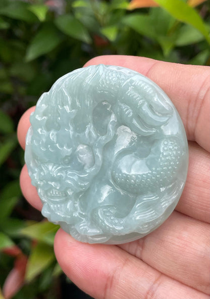 Untreated Type A Burmese jade pendant showing a smooth polished finish with an intricate Dragon carving