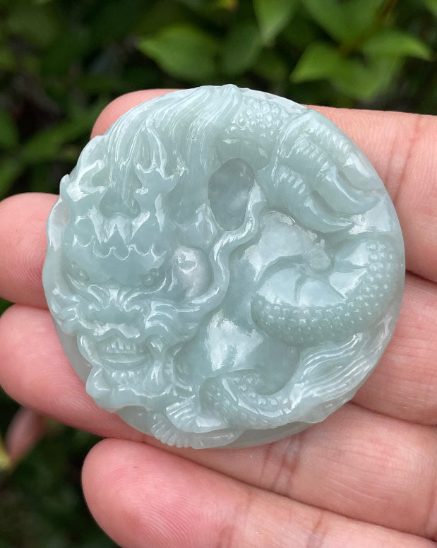 Untreated Type A Burmese jade pendant showing a smooth polished finish with an intricate Dragon carving