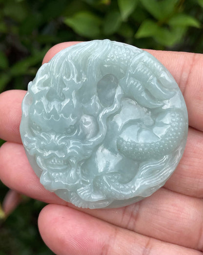 Untreated Type A Burmese jade pendant showing a smooth polished finish with an intricate Dragon carving