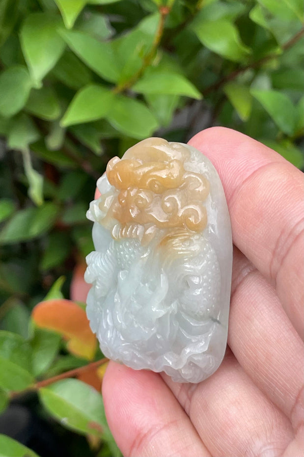 Untreated Type A Burmese jade pendant showing a smooth polished finish with an intricate Dragon carving