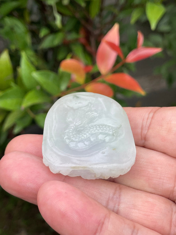 Untreated Type A Burmese jade pendant showing a smooth polished finish with an intricate Dragon carving