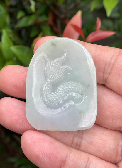Untreated Type A Burmese jade pendant showing a smooth polished finish with an intricate Dragon carving
