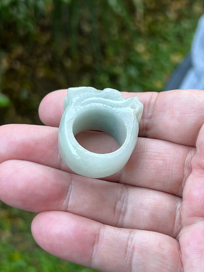 Close-up of layered body and scale detailing on a hand-carved dragon motif semi-translucent icy bluish-white Burmese jade ring