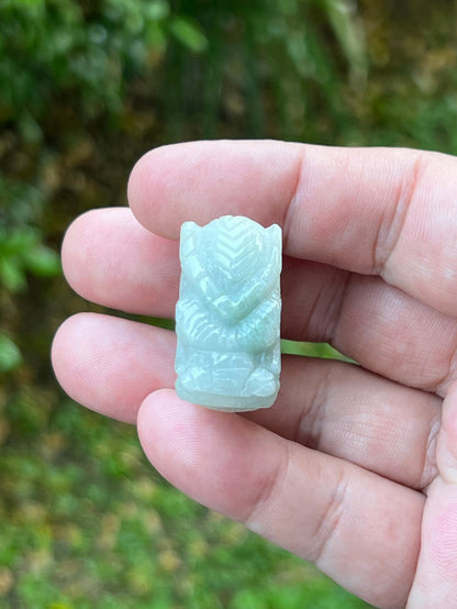 Close-up of layered body and scale detailing on a hand-carved dragon motif semi-translucent icy bluish-white Burmese jade ring