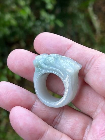 Close-up of layered body and scale detailing on a hand-carved dragon motif semi-translucent icy bluish-white Burmese jade ring