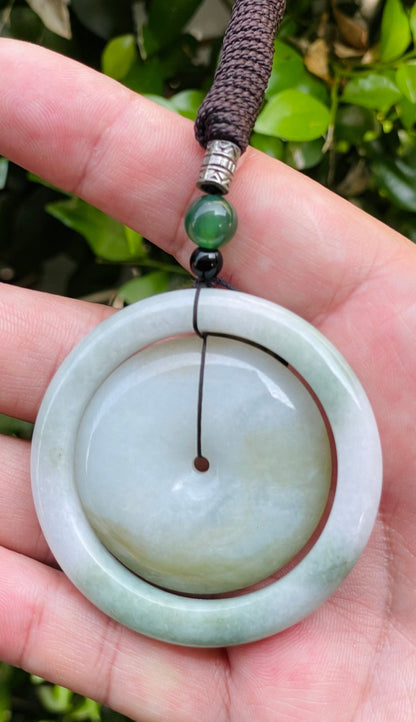 Smooth and polished texture of the authentic Myanmar jade pendant JP060 showcasing a dual-ring Feng Shui design for harmony and eternity