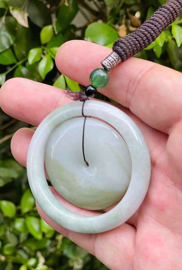 Smooth and polished texture of the authentic Myanmar jade pendant JP060 showcasing a dual-ring Feng Shui design for harmony and eternity