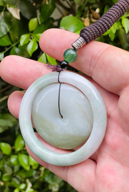 Smooth and polished texture of the authentic Myanmar jade pendant JP060 showcasing a dual-ring Feng Shui design for harmony and eternity