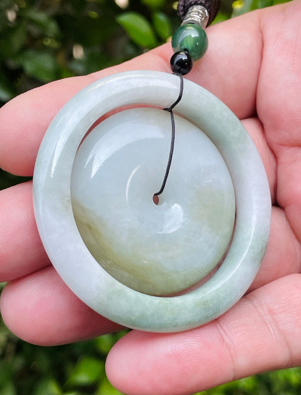Smooth and polished texture of the authentic Myanmar jade pendant JP060 showcasing a dual-ring Feng Shui design for harmony and eternity