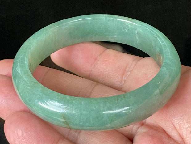 Close-up of fine crystalline texture and rare honey brown hues on icy apple and emerald green jadeite bangle