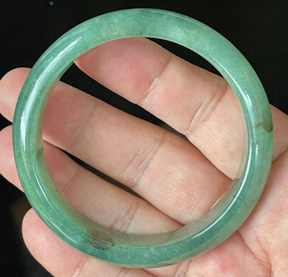 Close-up of fine crystalline texture and rare honey brown hues on icy apple and emerald green jadeite bangle