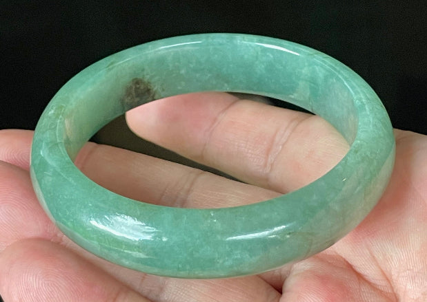 Close-up of fine crystalline texture and rare honey brown hues on icy apple and emerald green jadeite bangle