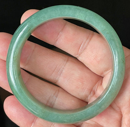 Close-up of fine crystalline texture and rare honey brown hues on icy apple and emerald green jadeite bangle
