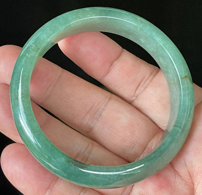 Close-up of fine crystalline texture and rare honey brown hues on icy apple and emerald green jadeite bangle