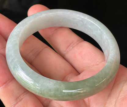 Close-up of fine crystalline texture and delicate lavender hues on icy greyish white and green jadeite bangle