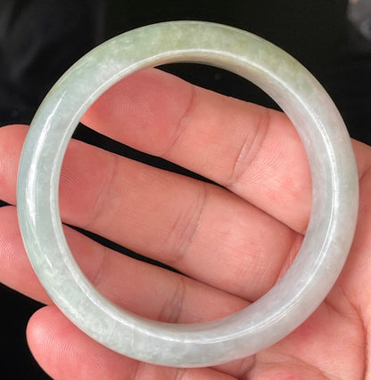 Close-up of fine crystalline texture and delicate lavender hues on icy greyish white and green jadeite bangle