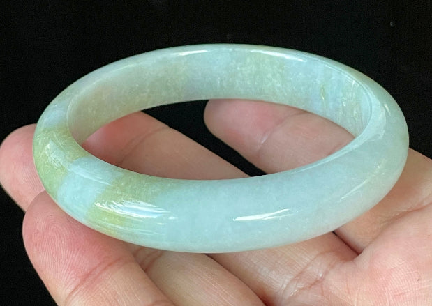 Close-up of fine crystalline texture and gentle light lavender hues on icy apple green and white jadeite bangle