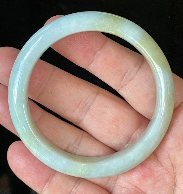 Close-up of fine crystalline texture and gentle light lavender hues on icy apple green and white jadeite bangle