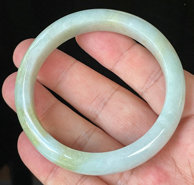 Close-up of fine crystalline texture and gentle light lavender hues on icy apple green and white jadeite bangle