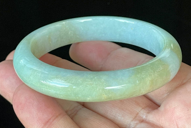 Close-up of fine crystalline texture and gentle light lavender hues on icy apple green and white jadeite bangle