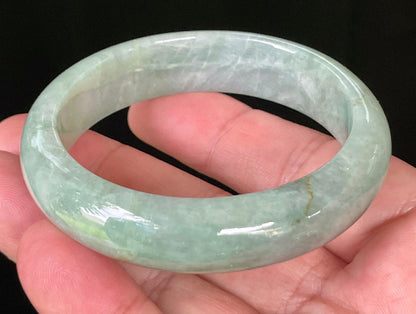 Close-up of fine crystalline texture and bluish apple green hues on icy greyish white jadeite bangle