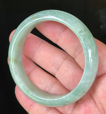 Close-up of fine crystalline texture and bluish apple green hues on icy greyish white jadeite bangle