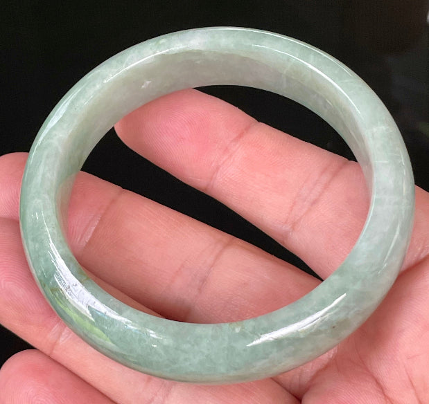 Close-up of fine crystalline texture and bluish apple green hues on icy greyish white jadeite bangle