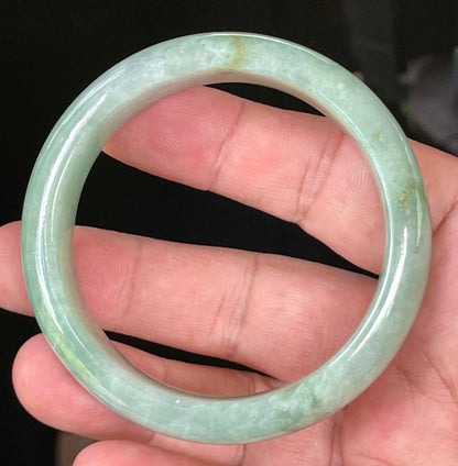 Close-up of fine crystalline texture and bluish apple green hues on icy greyish white jadeite bangle