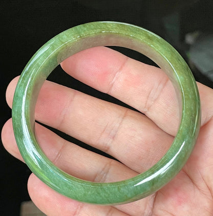 Close-up of fine crystalline texture and vibrant apple green hues on icy emerald jadeite bangle