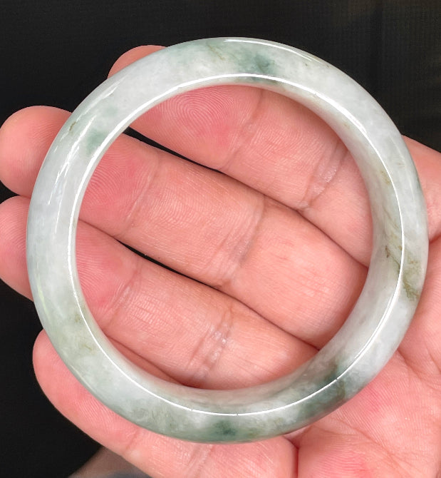 Close-up of fine crystalline texture and moss in the snow effect on rare icy greyish white and imperial green jadeite bangle