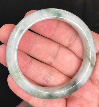 Close-up of fine crystalline texture and moss in the snow effect on rare icy greyish white and imperial green jadeite bangle