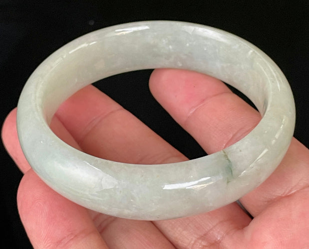 Close-up of fine crystalline texture and a striking imperial green line on very icy apple green jadeite bangle