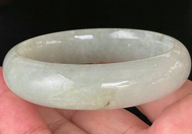 Close-up of fine crystalline texture and a striking imperial green line on very icy apple green jadeite bangle