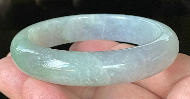 Close-up of fine crystalline texture and apple green hues on very icy lavender and white jadeite bangle