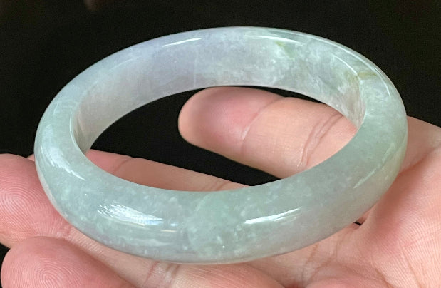Close-up of fine crystalline texture and apple green hues on very icy lavender and white jadeite bangle